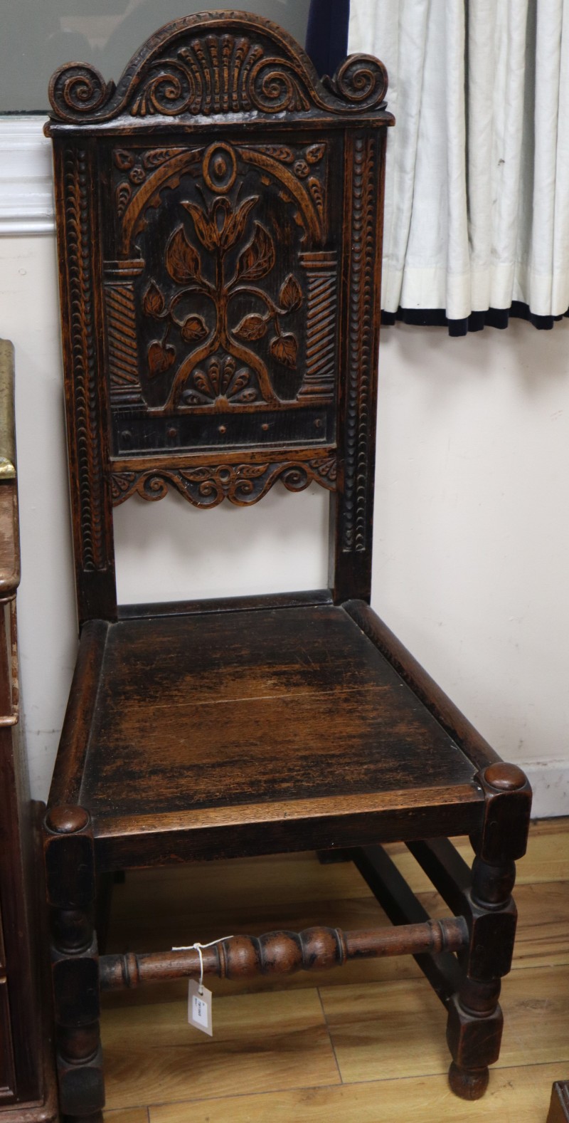 A pair of carved oak panel-back chairs